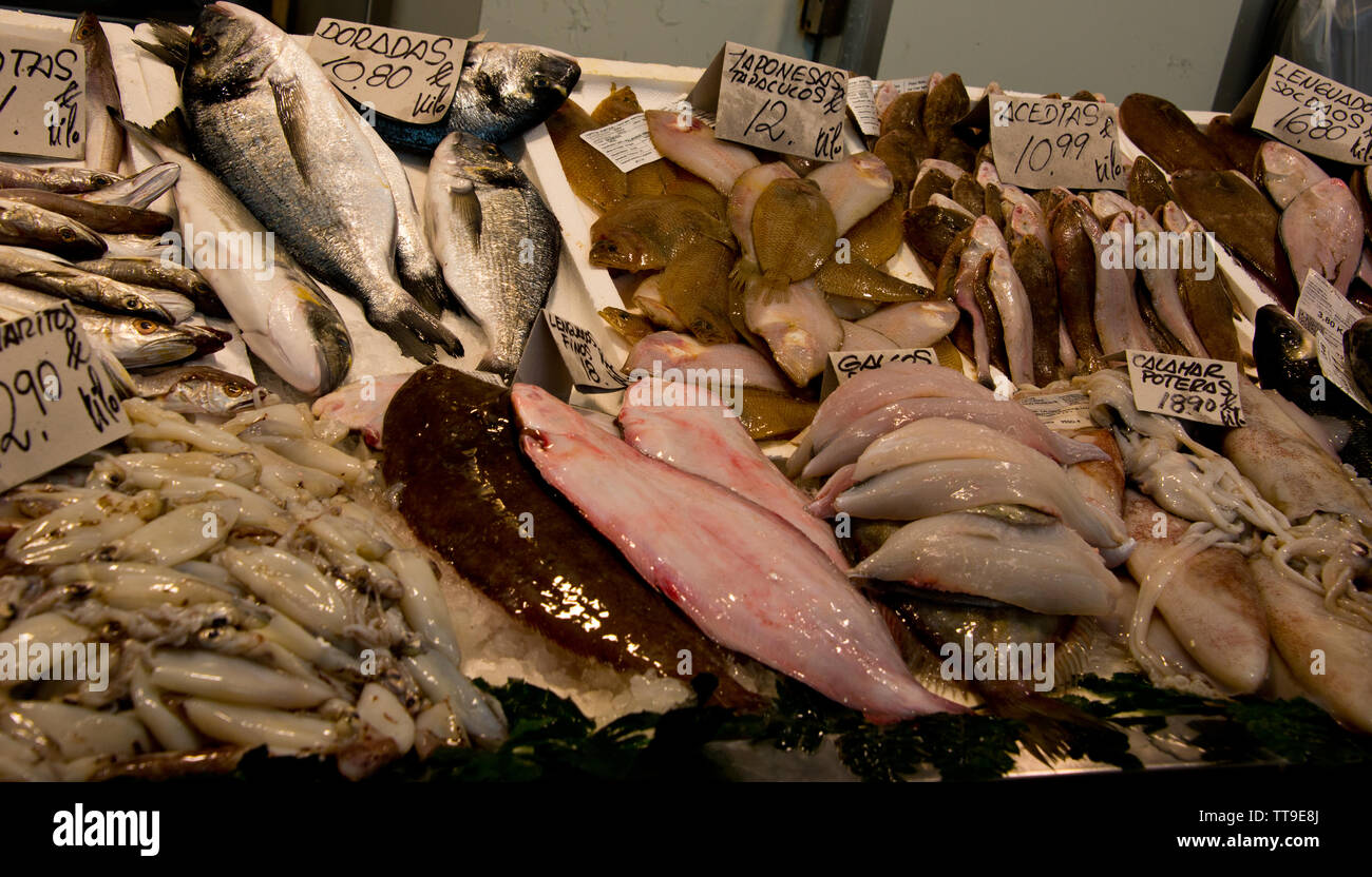 assorted mediterannean fish with prize tags at fishmonger's market stall in cadiz, andalusia, spain Stock Photo