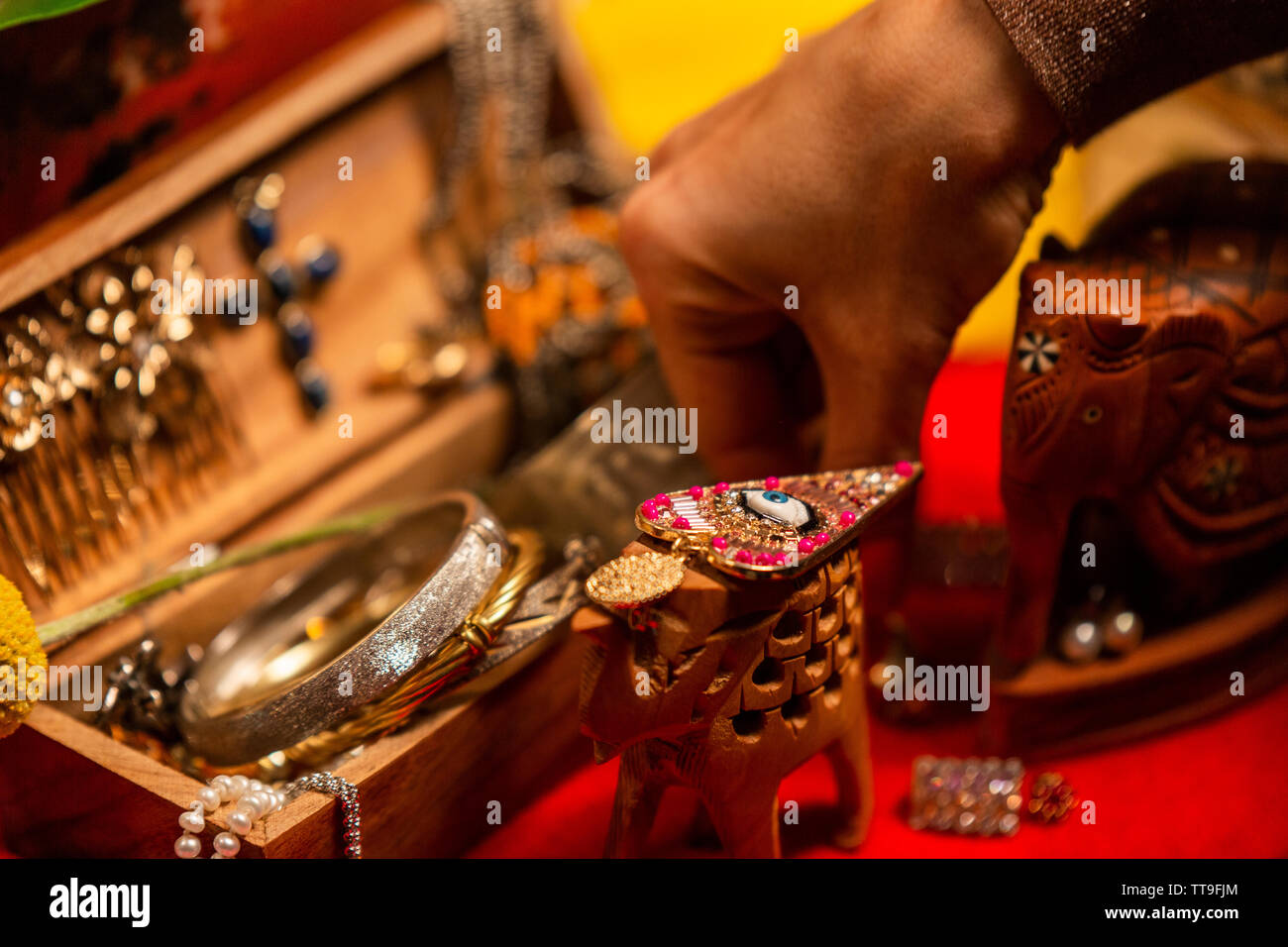 Cropped Hand decorationg Table with Jewellery Stock Photo