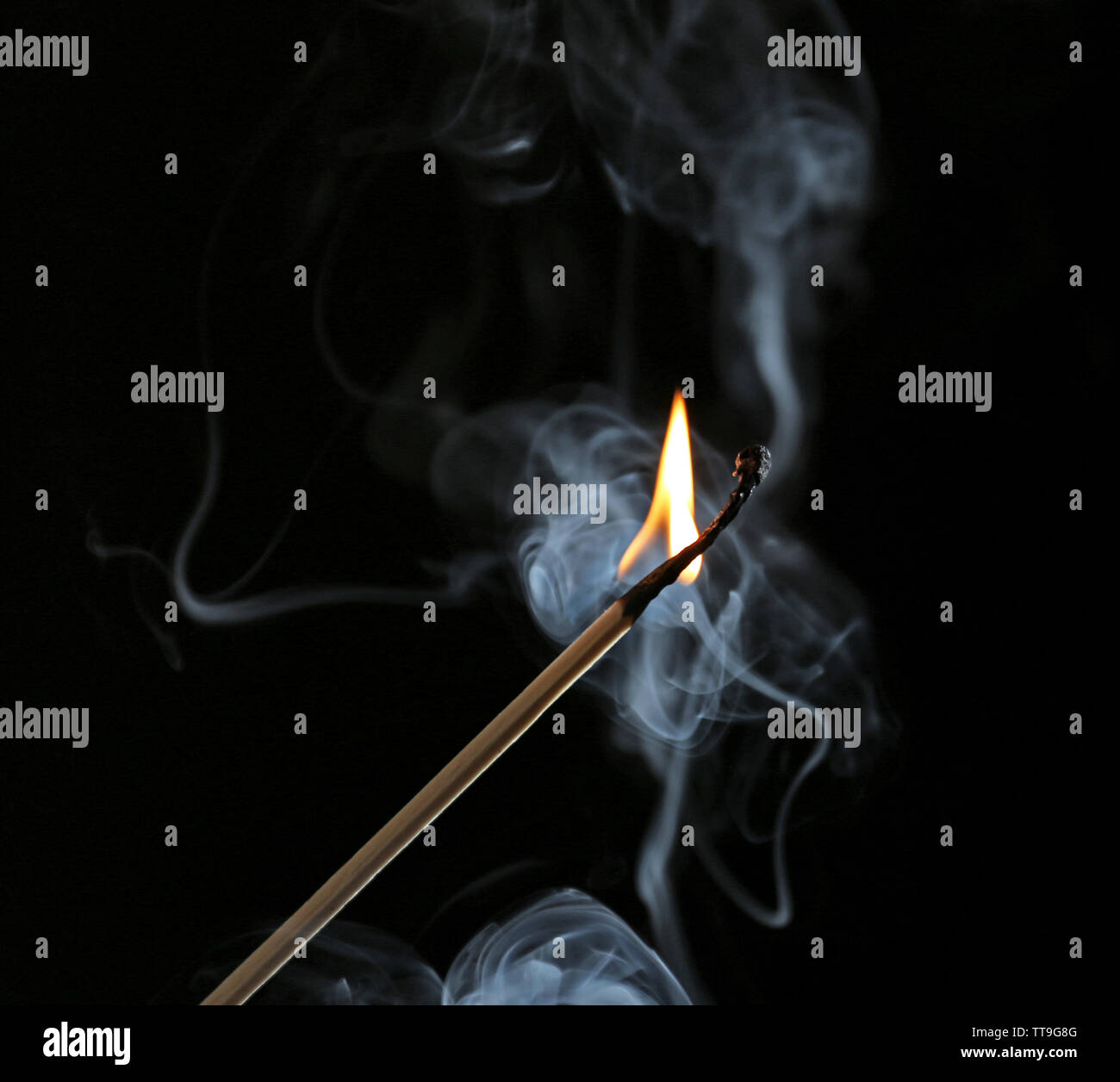 Burning match in smoke on dark background Stock Photo - Alamy