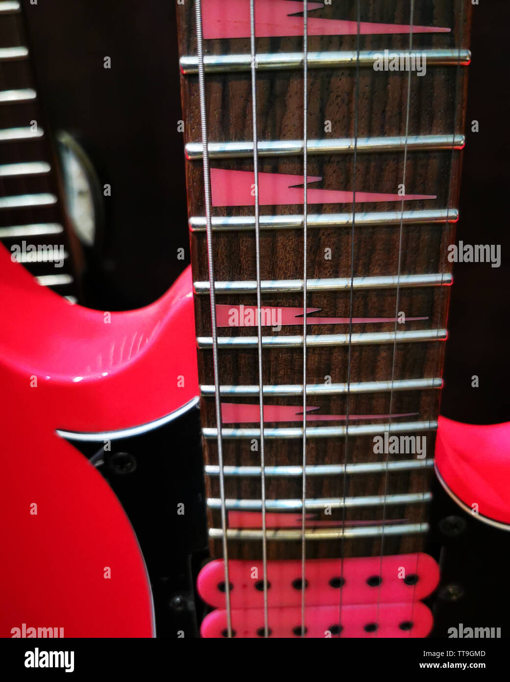 neon pink electric guitar details close up Stock Photo