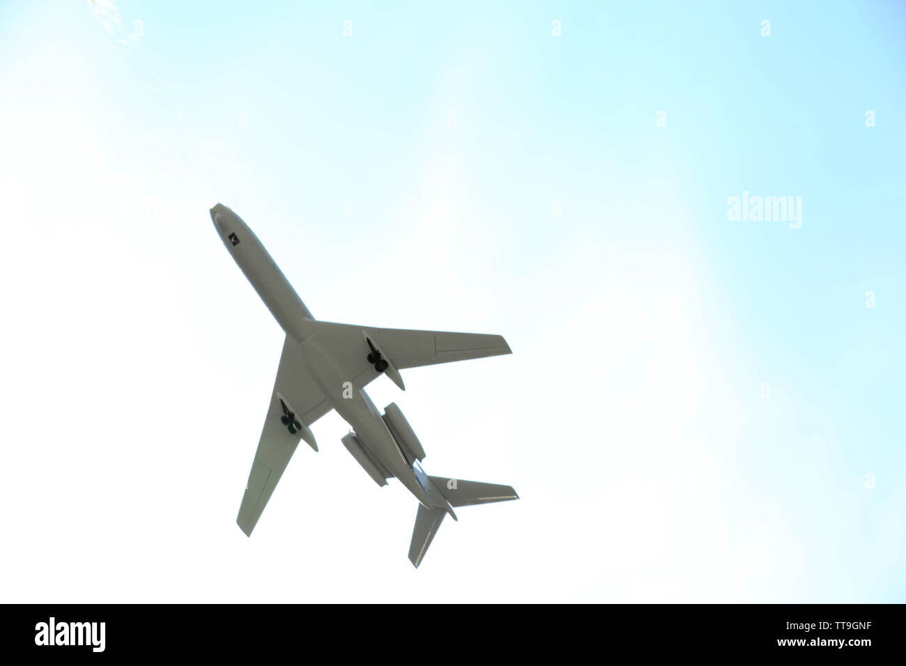 Model of plane over blue sky background Stock Photo - Alamy