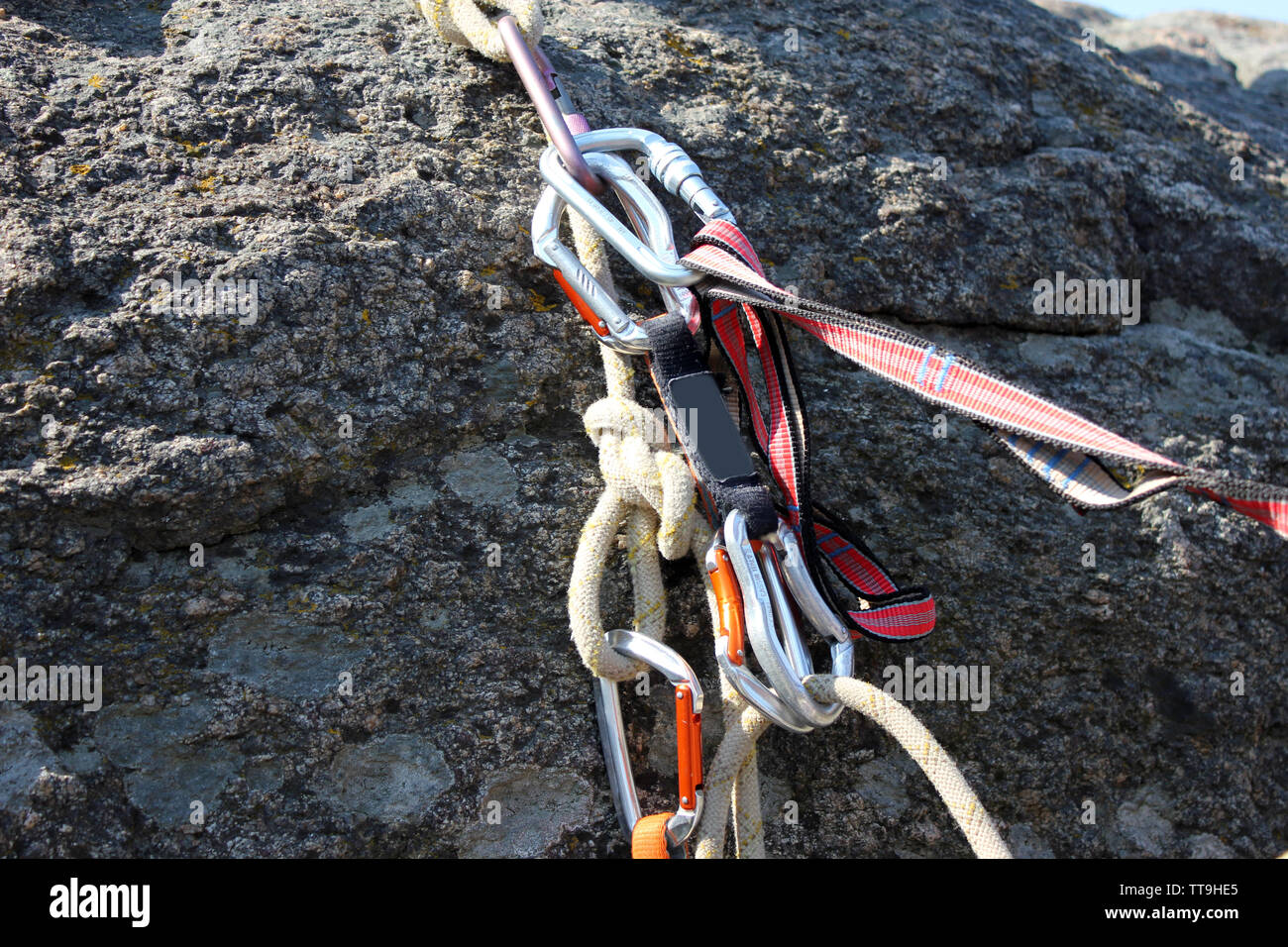 Rock climbing rope with hooks on rock, close-up Stock Photo - Alamy