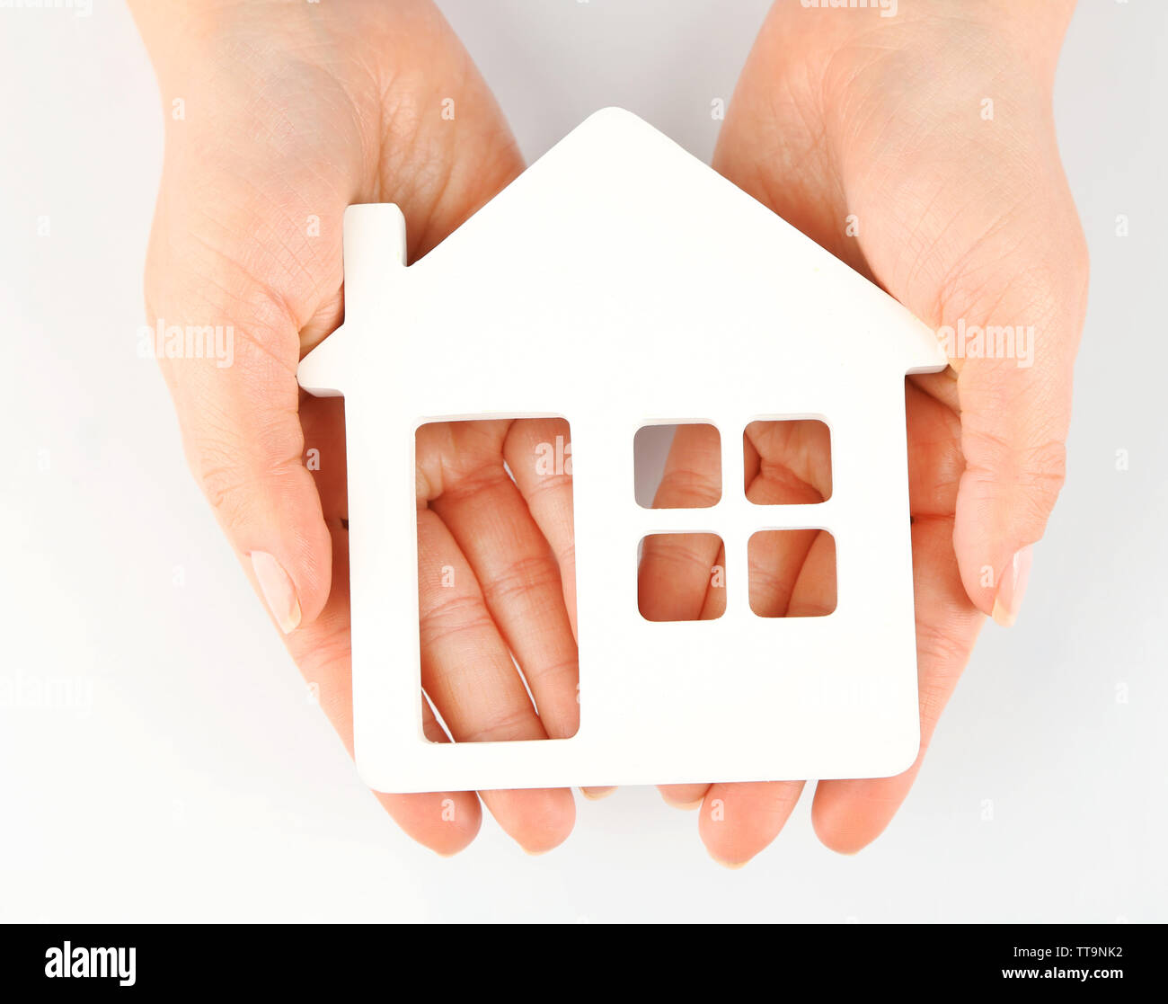 Female hands with model of house isolated on white Stock Photo - Alamy
