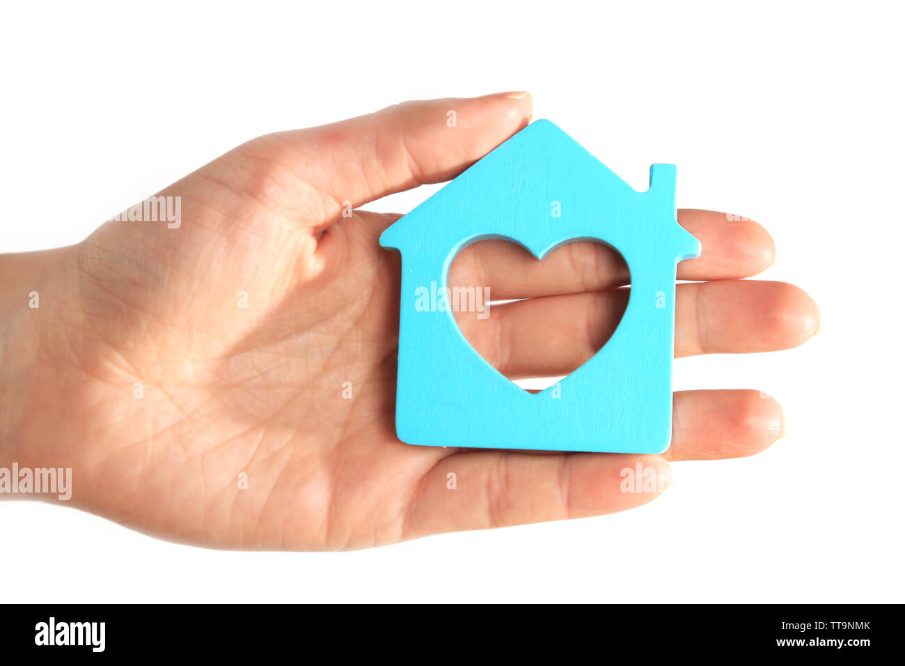 Female hand with model of house on blurred background Stock Photo - Alamy