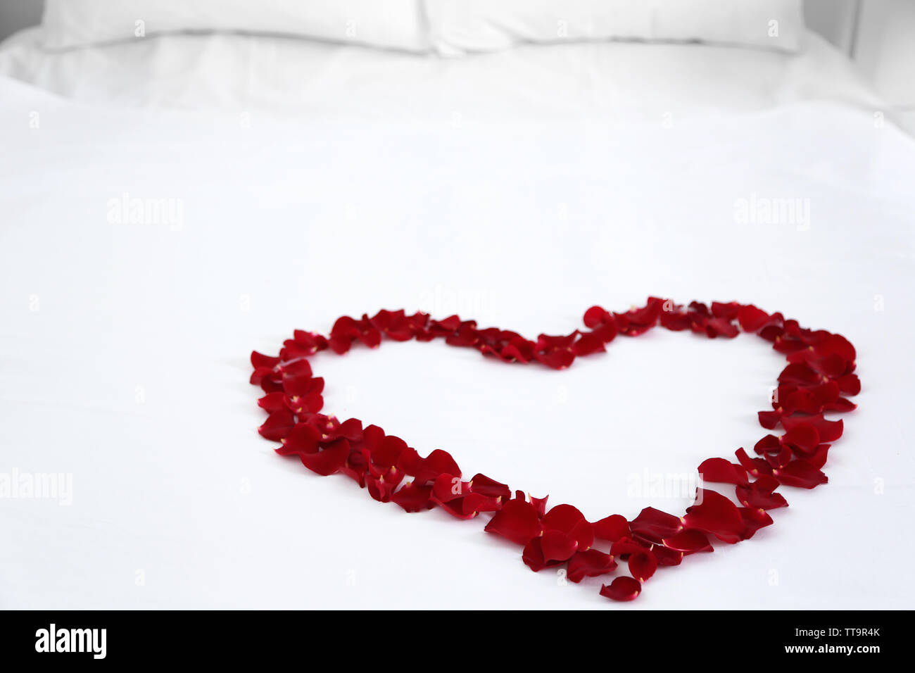 Heart Petals On Bed Photos and Images