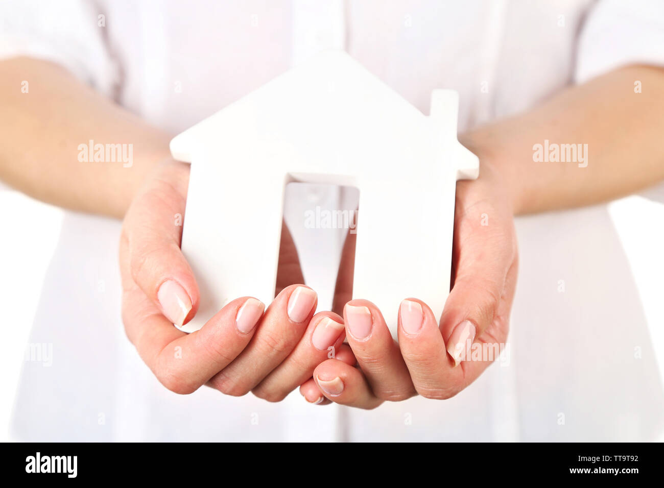Woman holding model of house close up Stock Photo - Alamy