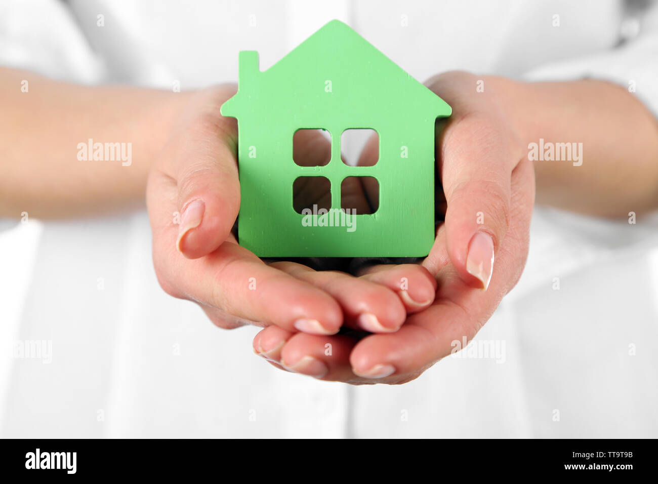 Woman holding model of house close up Stock Photo - Alamy
