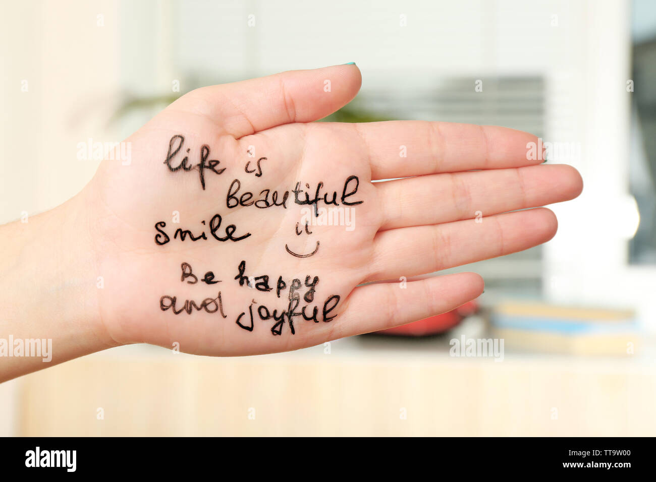 Female hand with written message in room Stock Photo