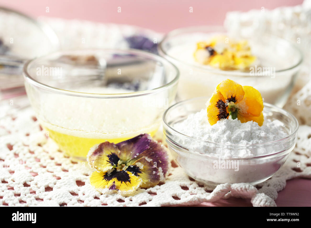 Making candied violet flowers with egg whites and sugar, on color