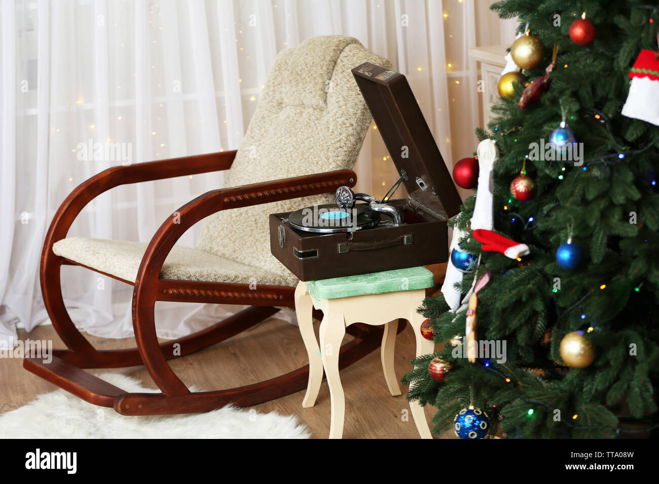 Beautiful Christmas interior with fireplace, turntable and fir tree