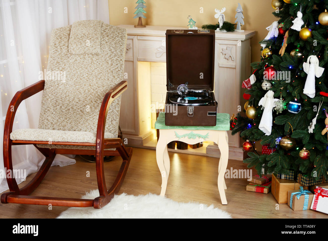 Beautiful Christmas interior with fireplace, turntable and fir tree