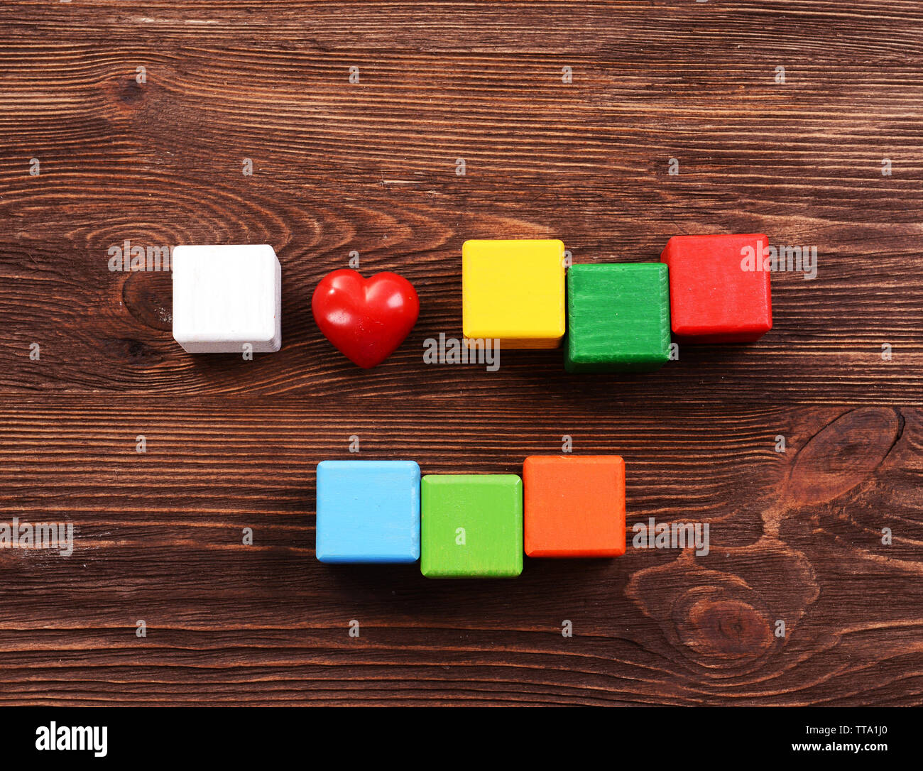 Colorful cubes for inscriptions on wooden background Stock Photo - Alamy
