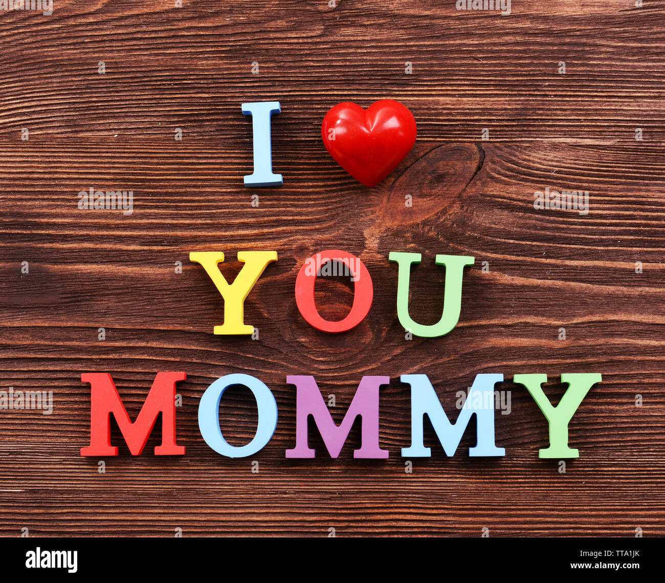 Inscription I LOVE YOU MUMMY made of colorful letters on wooden background  Stock Photo - Alamy