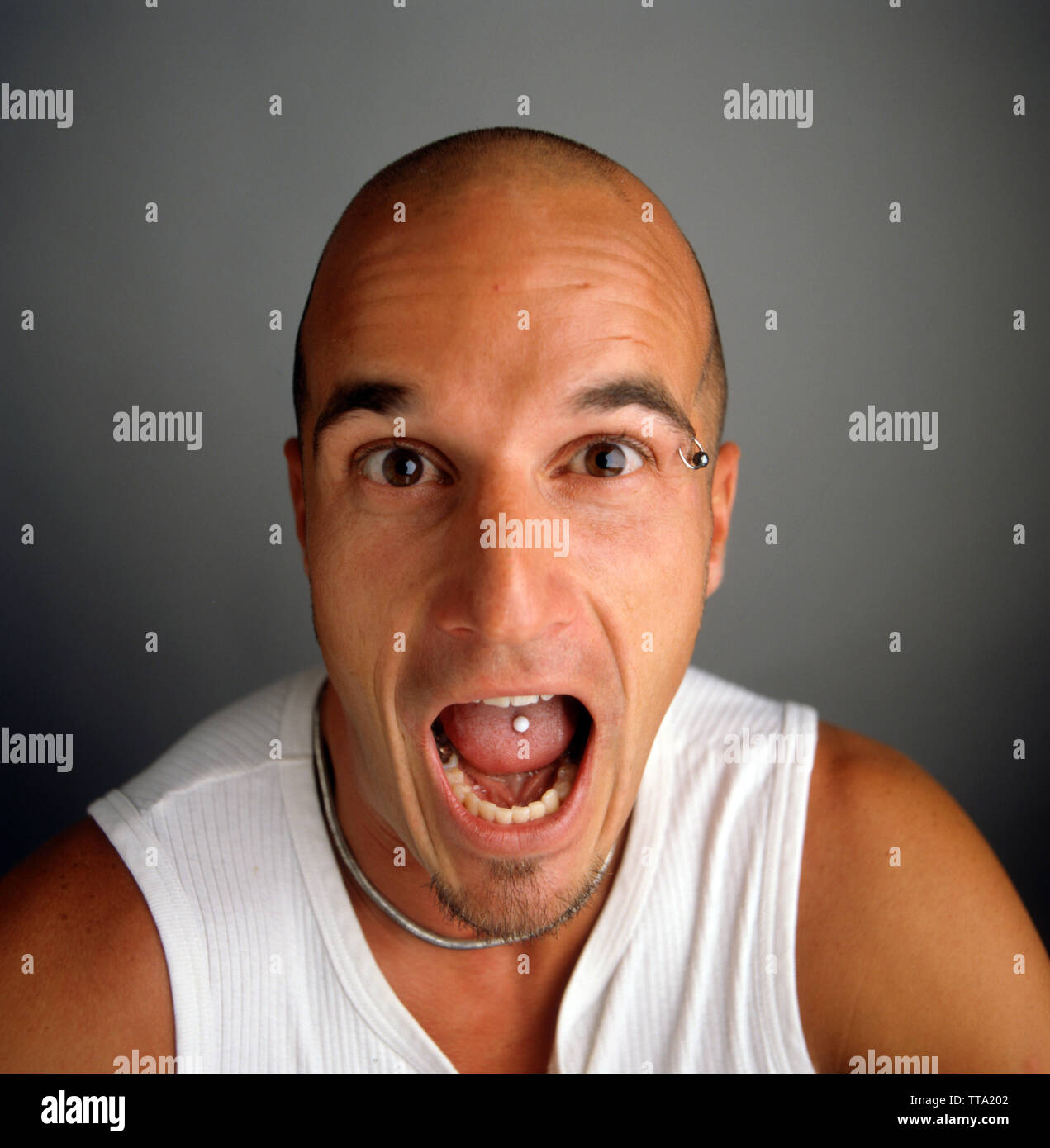 Angry guy with mouth open  with piercing Stock Photo