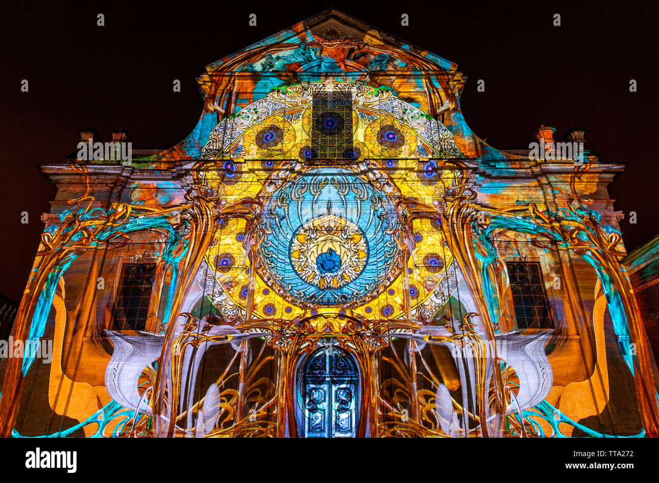 The baroque style facade of the Saint Peter's Abbey illuminated with colourful lights during the Ghent light festival (Gent in Flemish), Belgium. Stock Photo