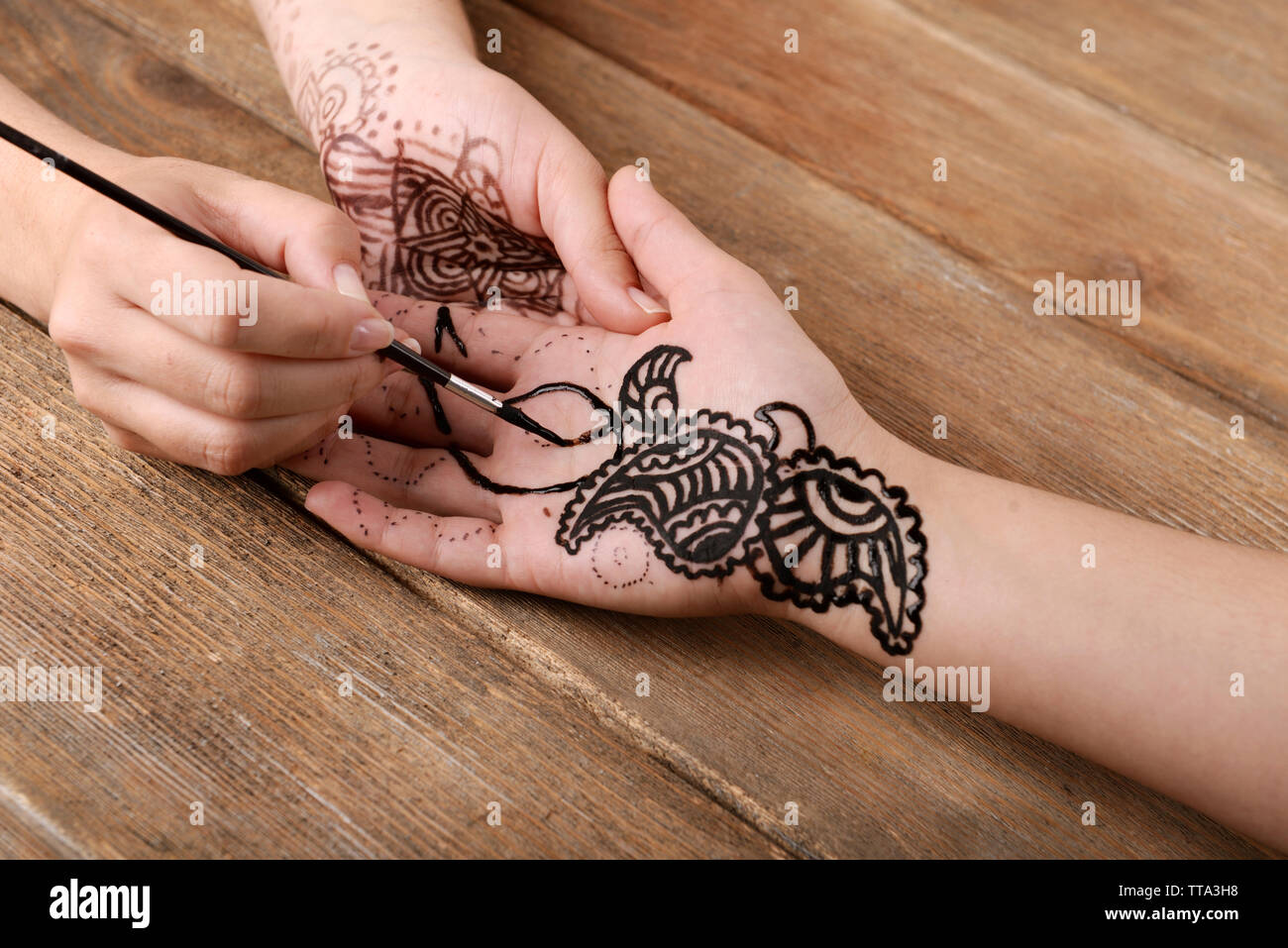 Process of applying Mehndi on female hand close up Stock Photo Alamy
