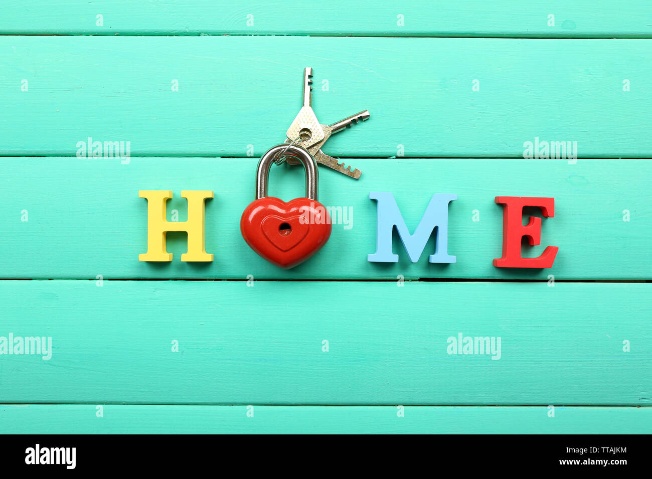 Decorative letters forming word HOME with lock and keys on wooden background  Stock Photo - Alamy