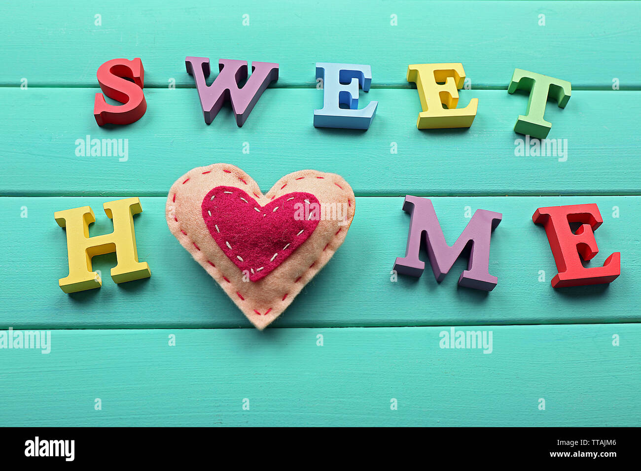 Decorative Letters Forming Words Sweet Home With Heart On Wooden