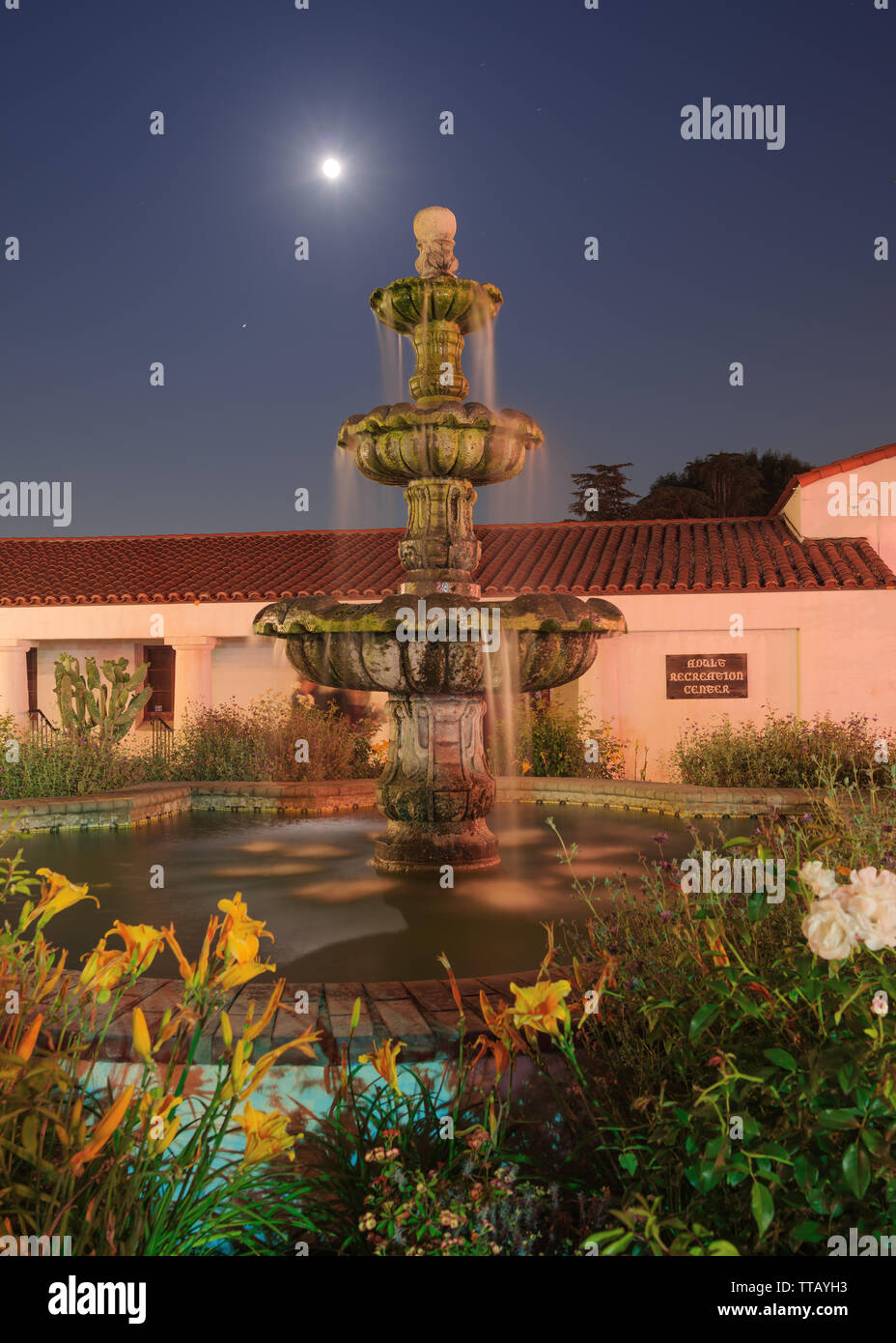 Long exposure of Constitution Fountain at the San Gabriel Mission Playhouse with the rising full moon in the background. Stock Photo