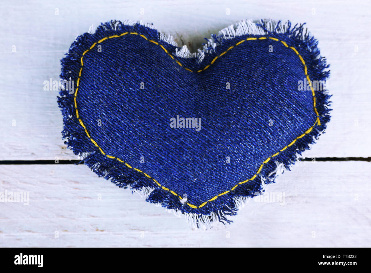 Denim heart on wooden background Stock Photo
