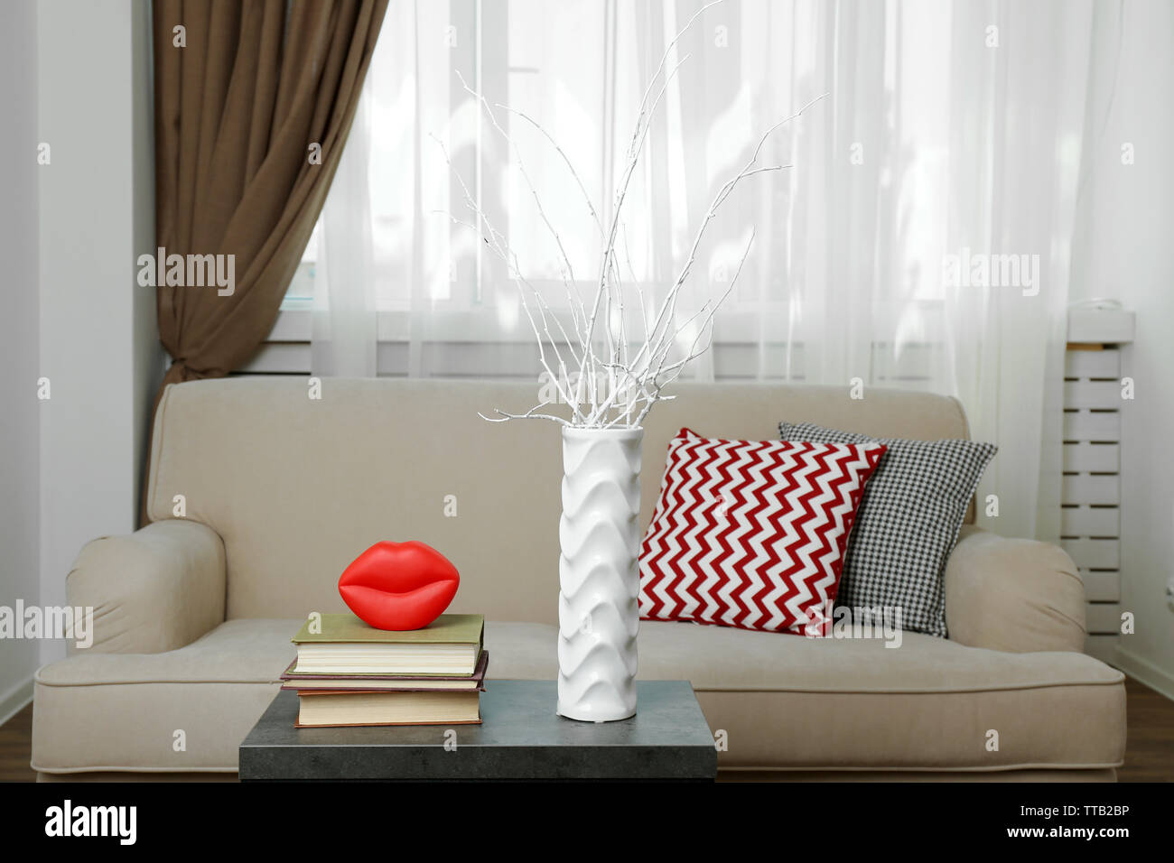 Interior of modern living room with sofa and table Stock Photo - Alamy