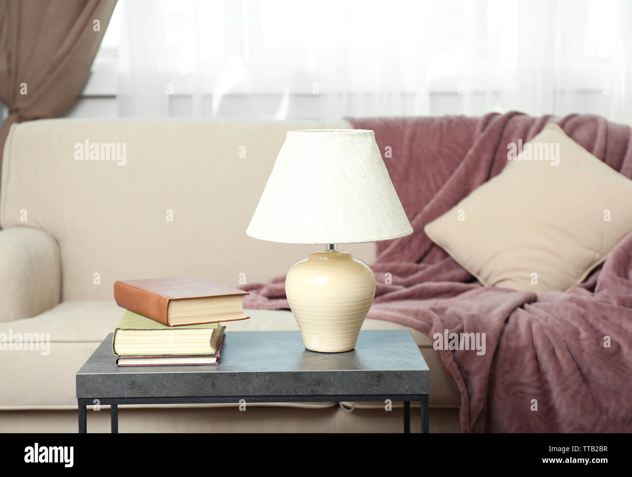 Interior of modern living room with sofa and table Stock Photo - Alamy
