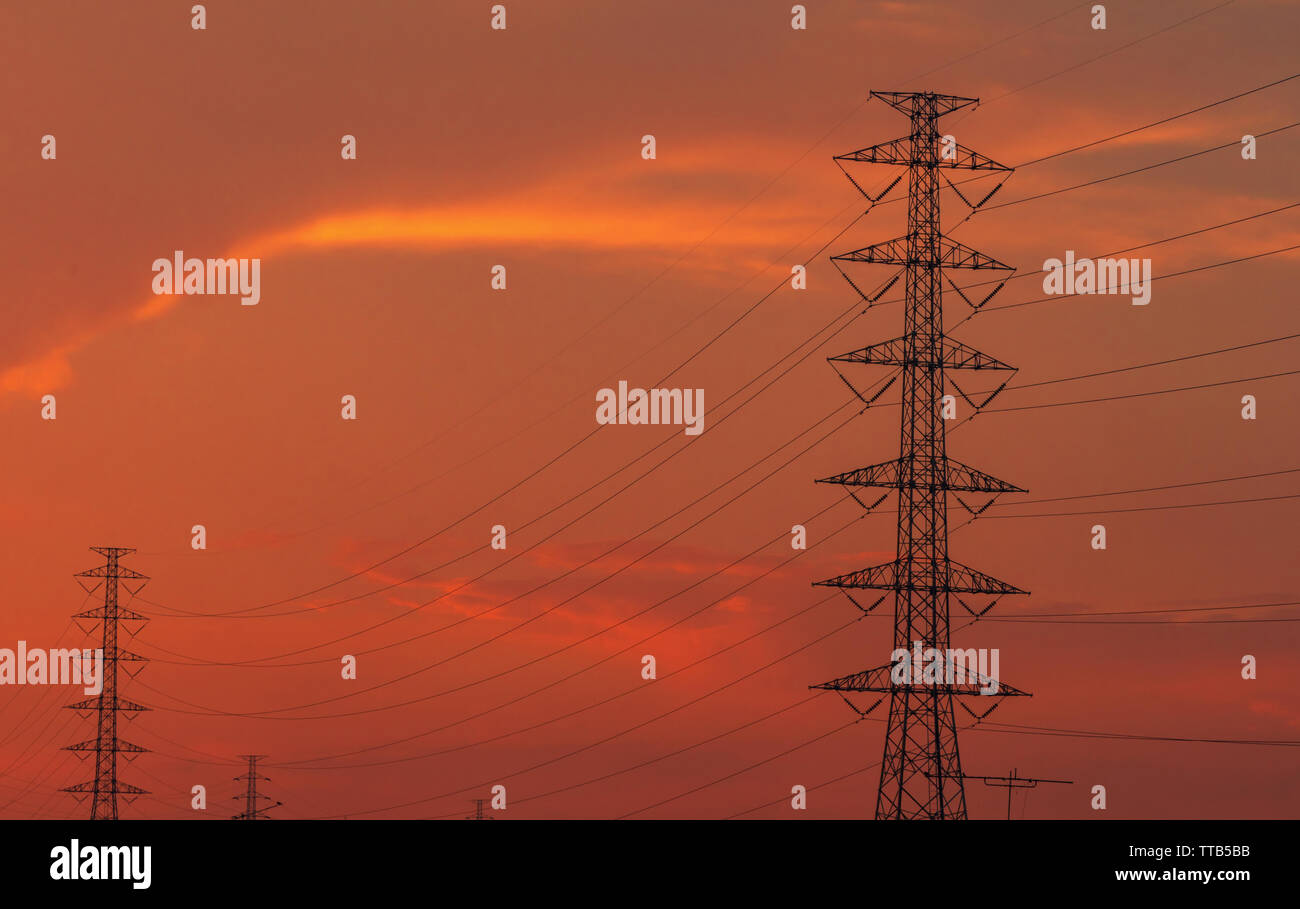 High voltage electric pole and transmission lines in the evening ...