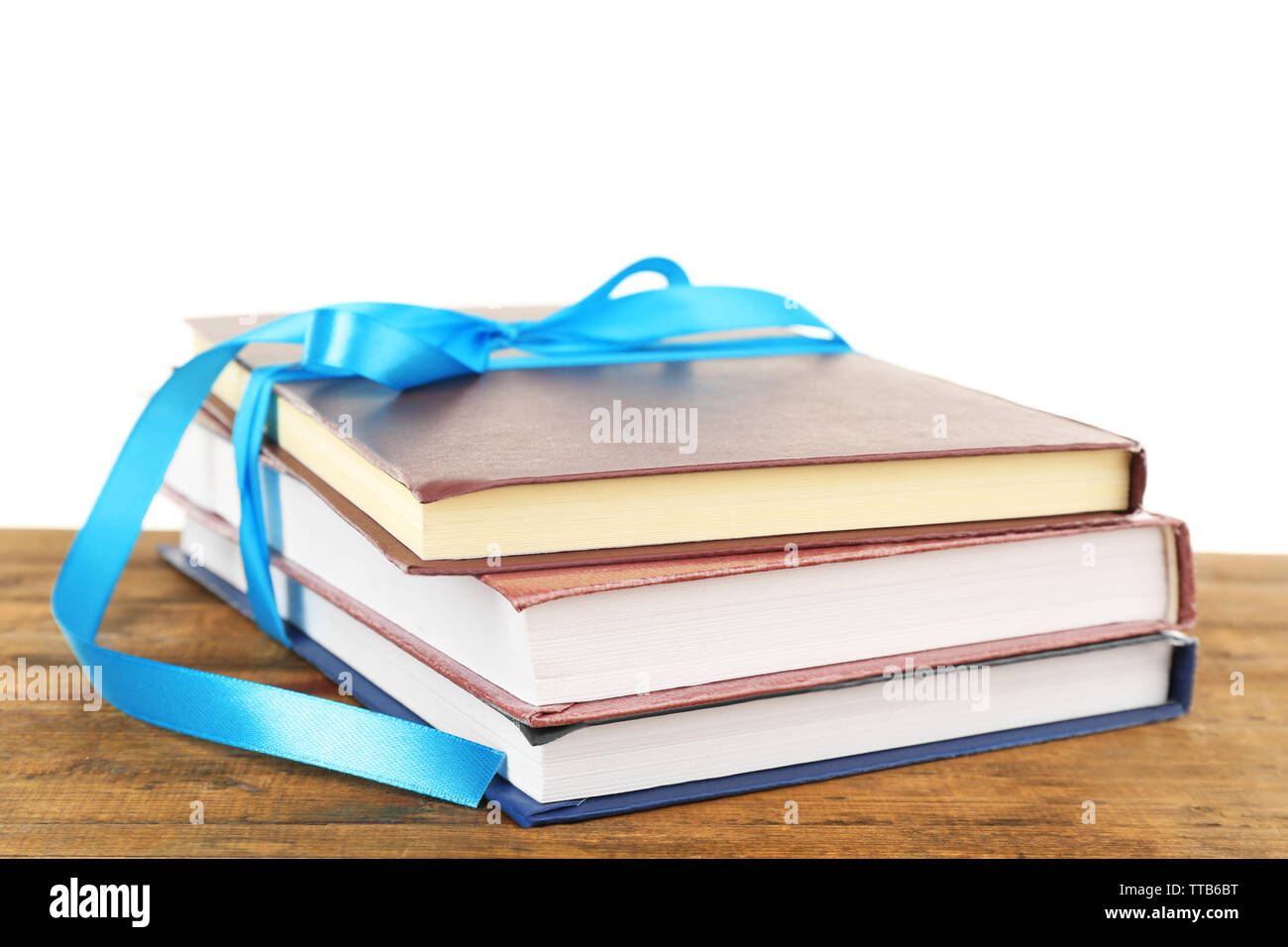 Book Stack With Ribbon Mark Stack of books with ribbon on table isolated on white Stock Photo - Alamy