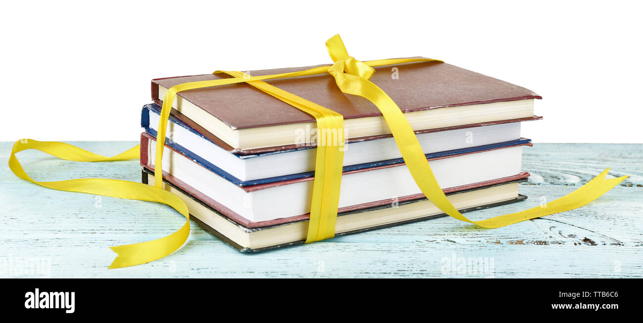 Book Stack With Ribbon Mark Stack of books with ribbon on table isolated on white Stock Photo - Alamy