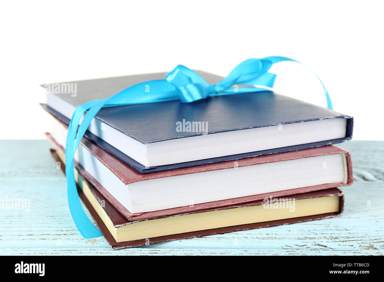 Book Stack With Ribbon Mark Stack of books with ribbon on light background Stock Photo - Alamy