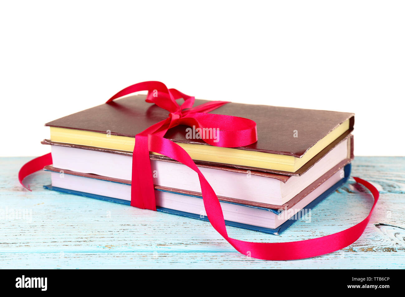 Book Stack With Ribbon Mark Stack of books with ribbon on table isolated on white Stock Photo - Alamy