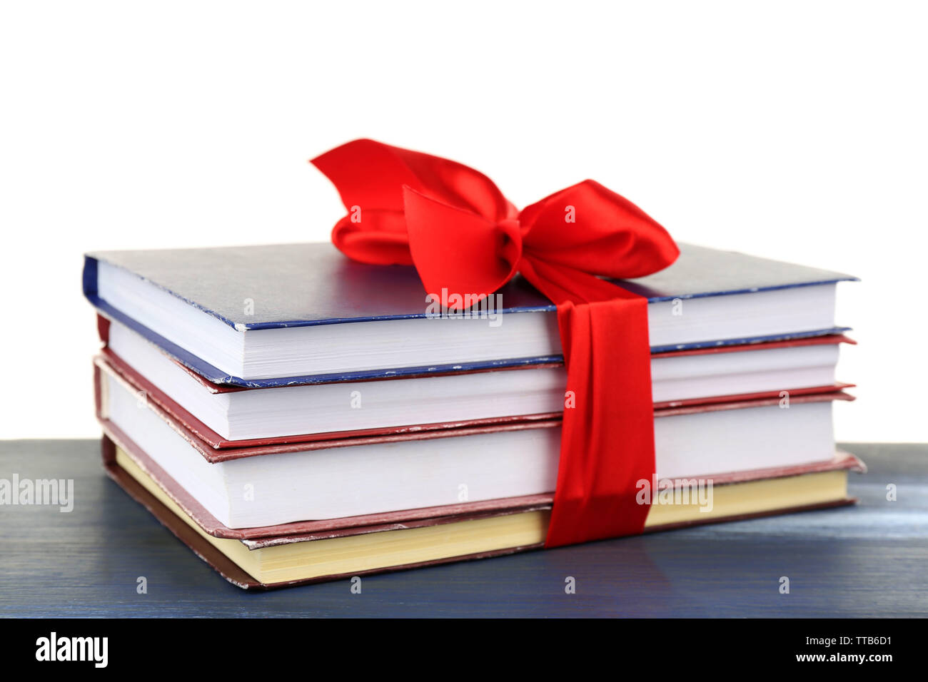 Book Stack With Ribbon Mark Stack of books with ribbon on table isolated on white Stock Photo - Alamy