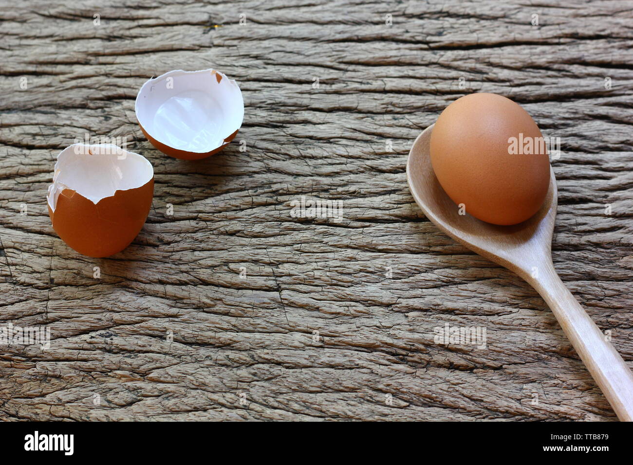 chicken egg with wood spoon on retor wood table background Stock Photo ...