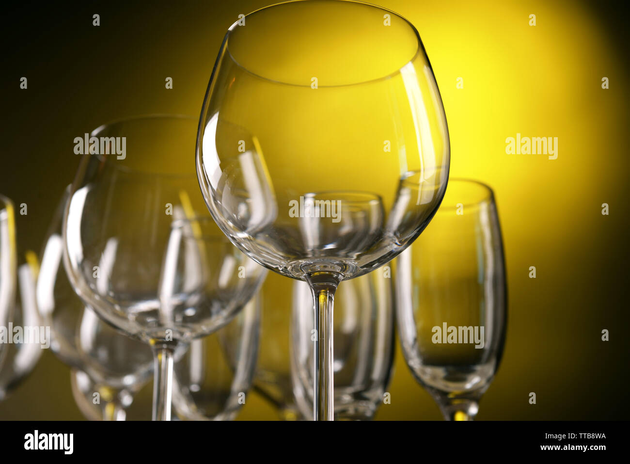 Empty wine glasses on yellow background Stock Photo