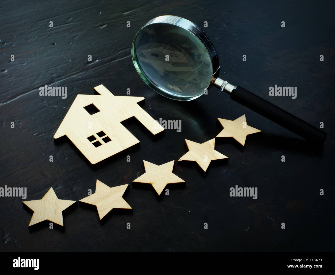 Property valuation and home appraisal. Model of house and five stars. Stock Photo