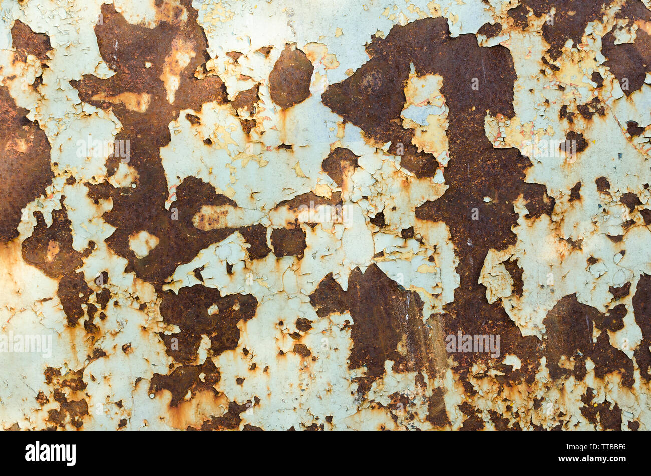 Old rusty metal surface is covered with peeling paint Stock Photo