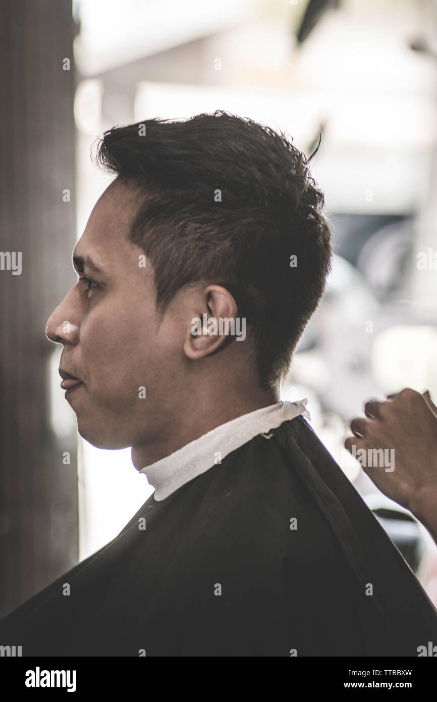 Side View Portrait Of Attractive Asian Man Having His Neck