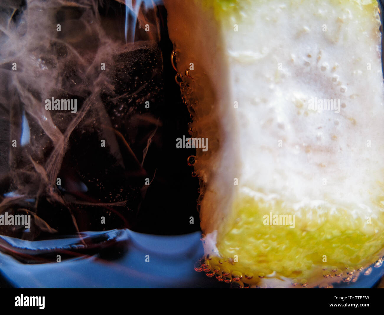 a glass of cola with ice and lemon Stock Photo - Alamy