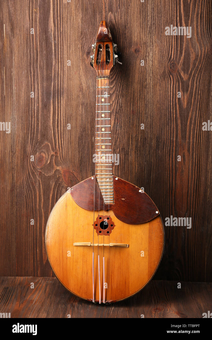 Folk musical instrument domra on wooden background Stock Photo