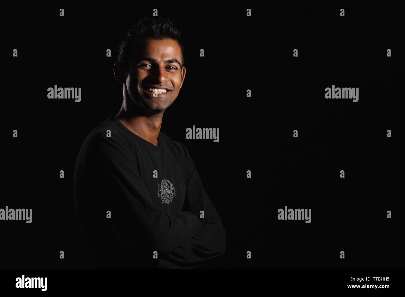 Portrait of a man smiling with arms crossed Stock Photo - Alamy