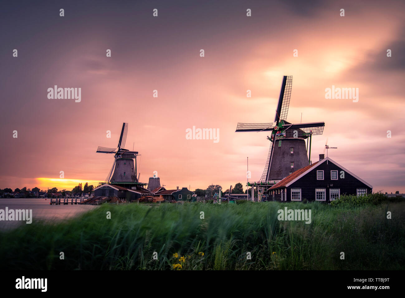 Windy and cloudy sunset in Zaanse Schans, Zaandam, Amsterdam, Holland Stock Photo