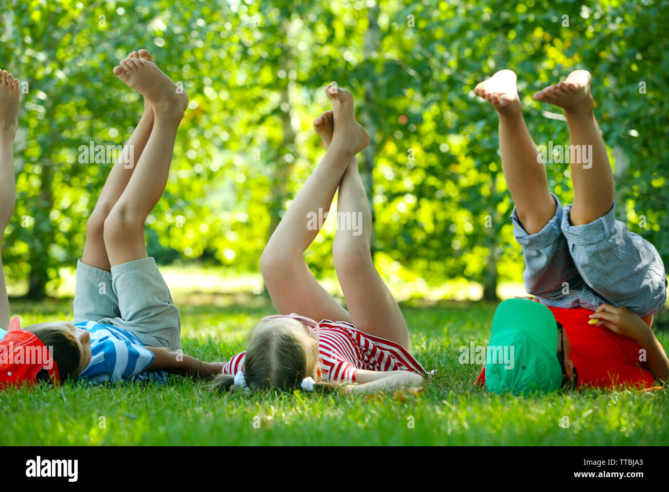 Boy lying on grass legs hi-res stock photography and images - Alamy