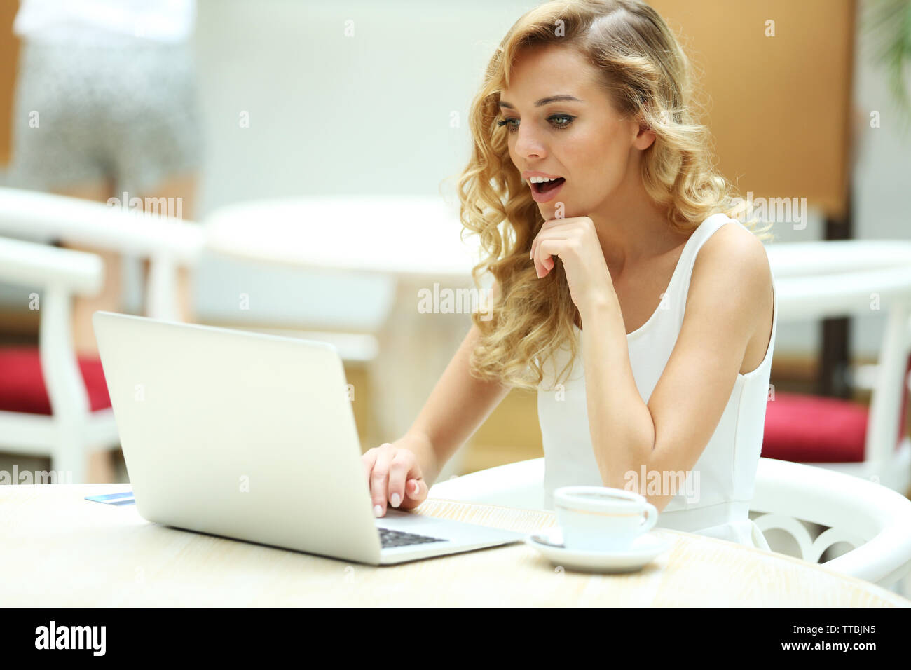 Beautiful young woman with laptop in cafe Stock Photo - Alamy