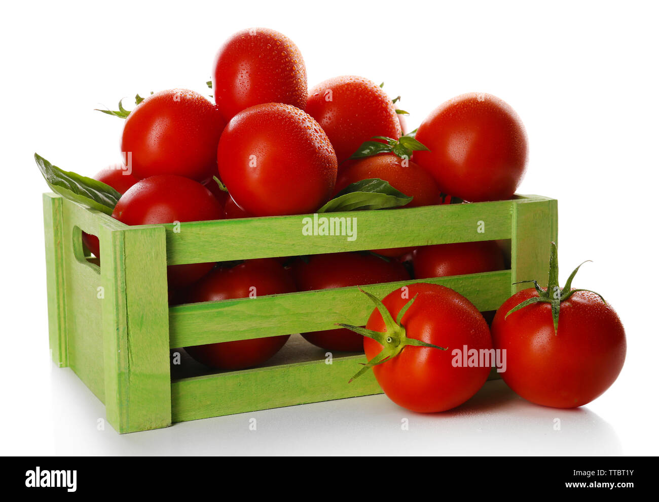 Red tomatoes in green wooden box isolated on white Stock Photo - Alamy