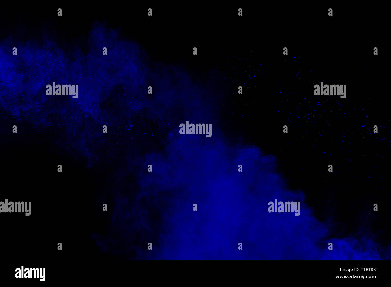 Blue color powder explosion cloud on black background.Closeup of Blue