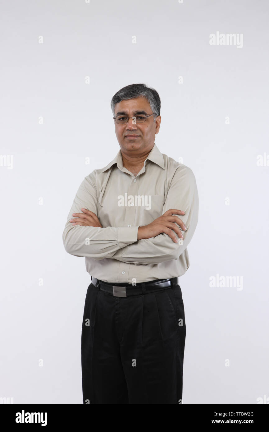 Indian businessman standing with his arms crossed Stock Photo - Alamy