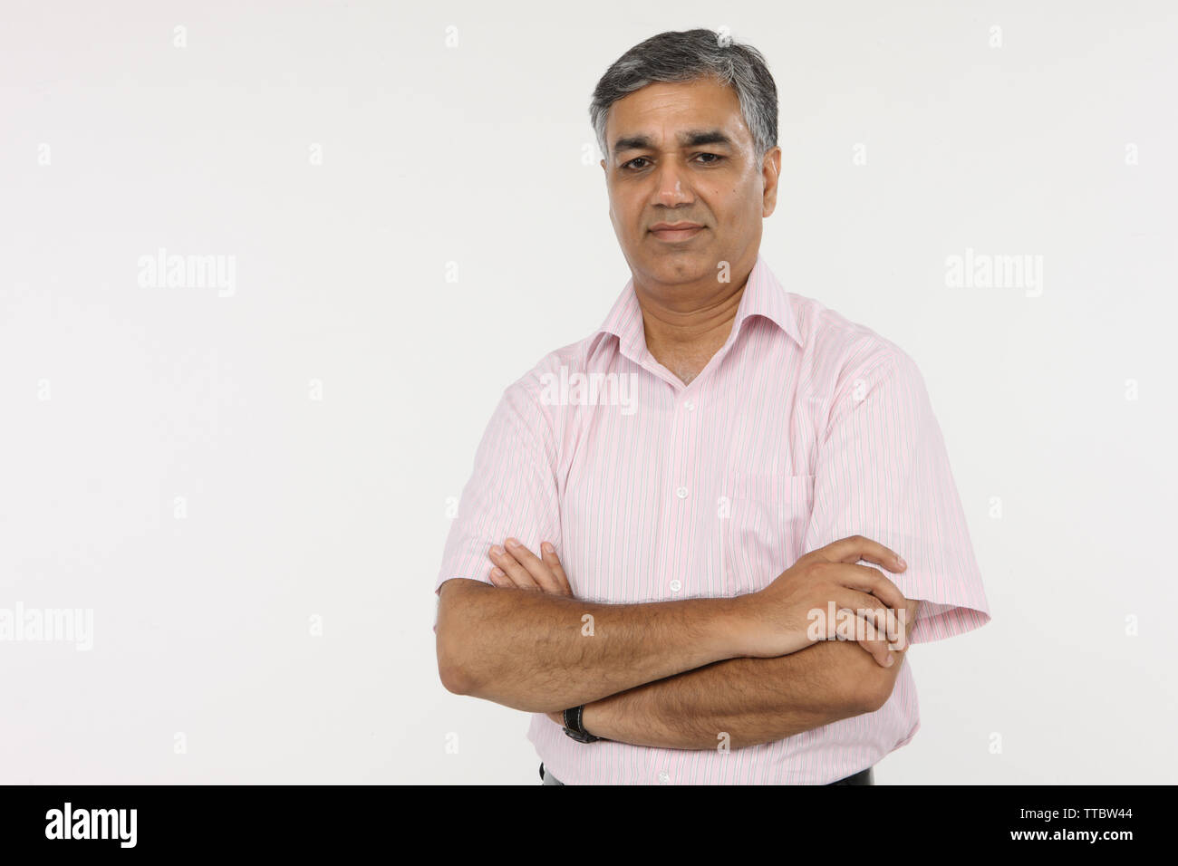 Portrait of a businessman with arms crossed Stock Photo - Alamy