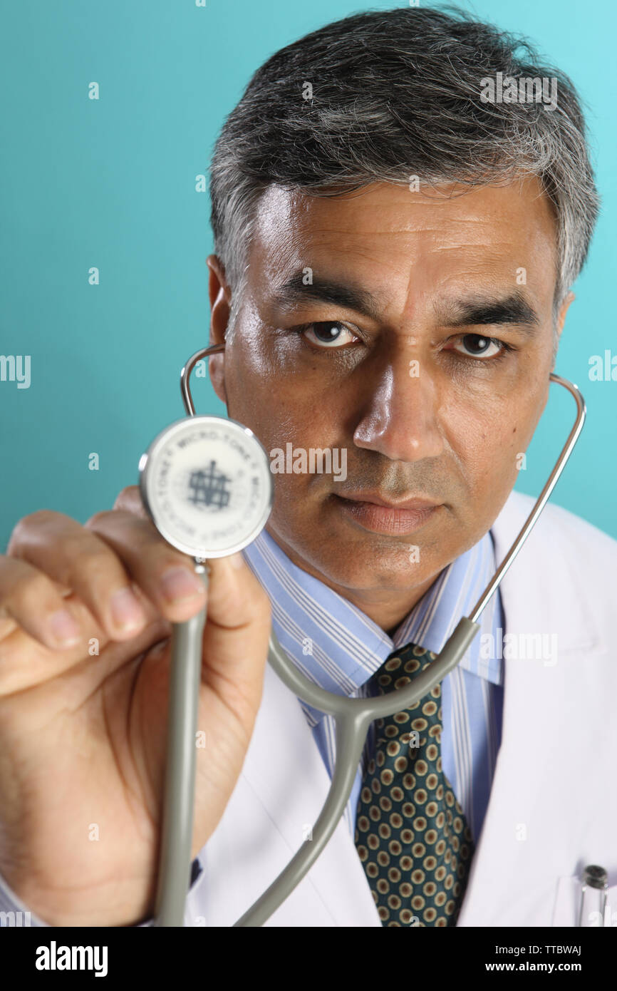 Male doctor holding a stethoscope Stock Photo - Alamy