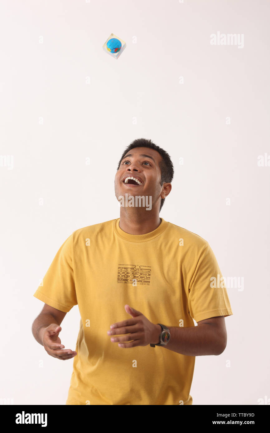 Man tossing a paperweight and smiling Stock Photo