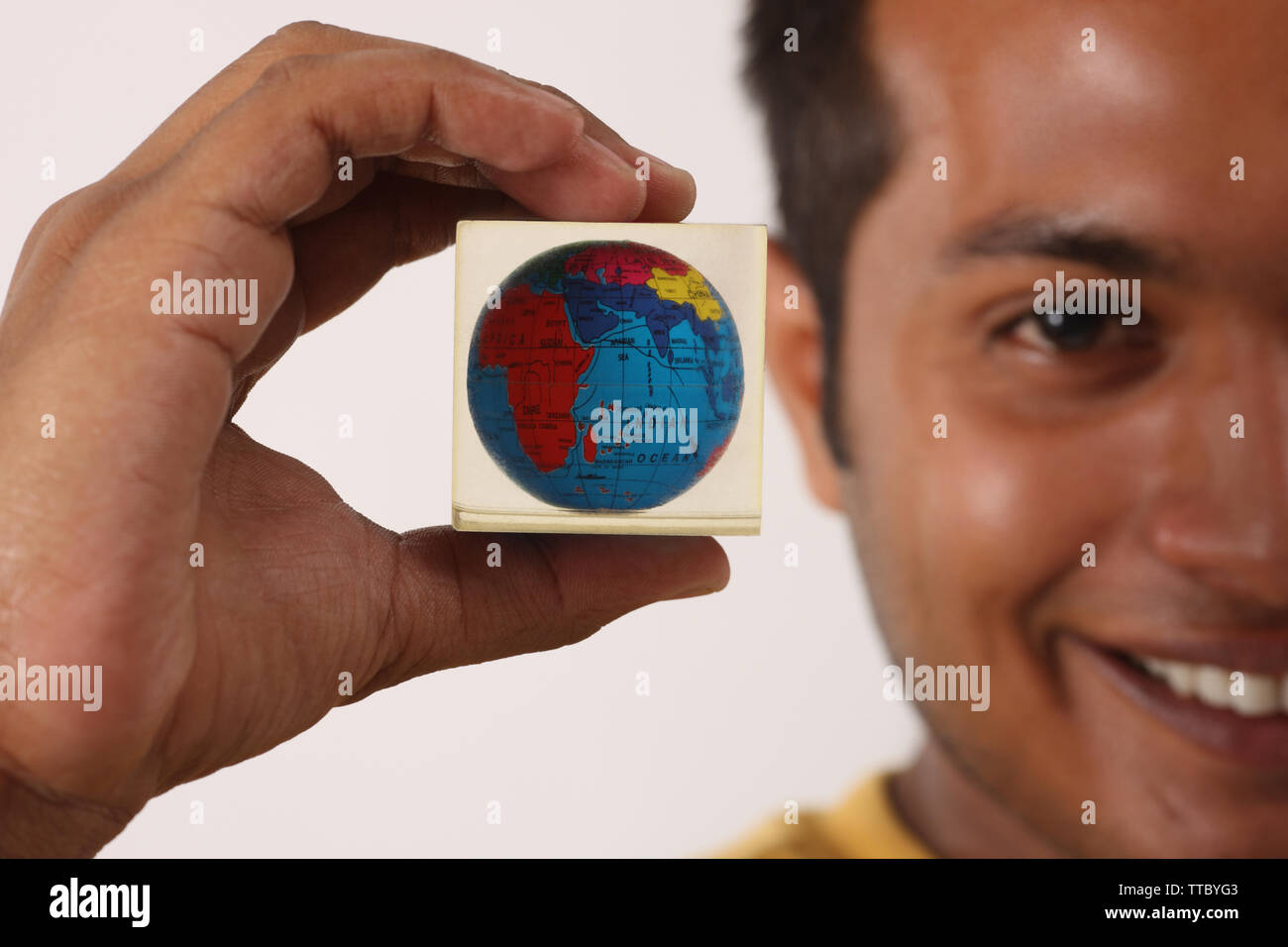 Man showing a paperweight and smiling Stock Photo